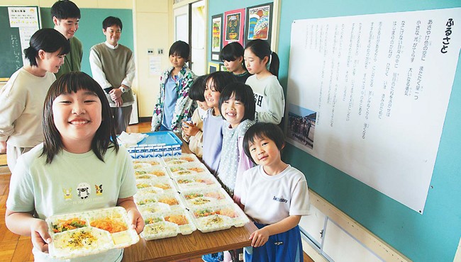 おしゃべりしながら給食を食べる子どもたち。机はまだ前を向いたままだ（千葉県いすみ市で）